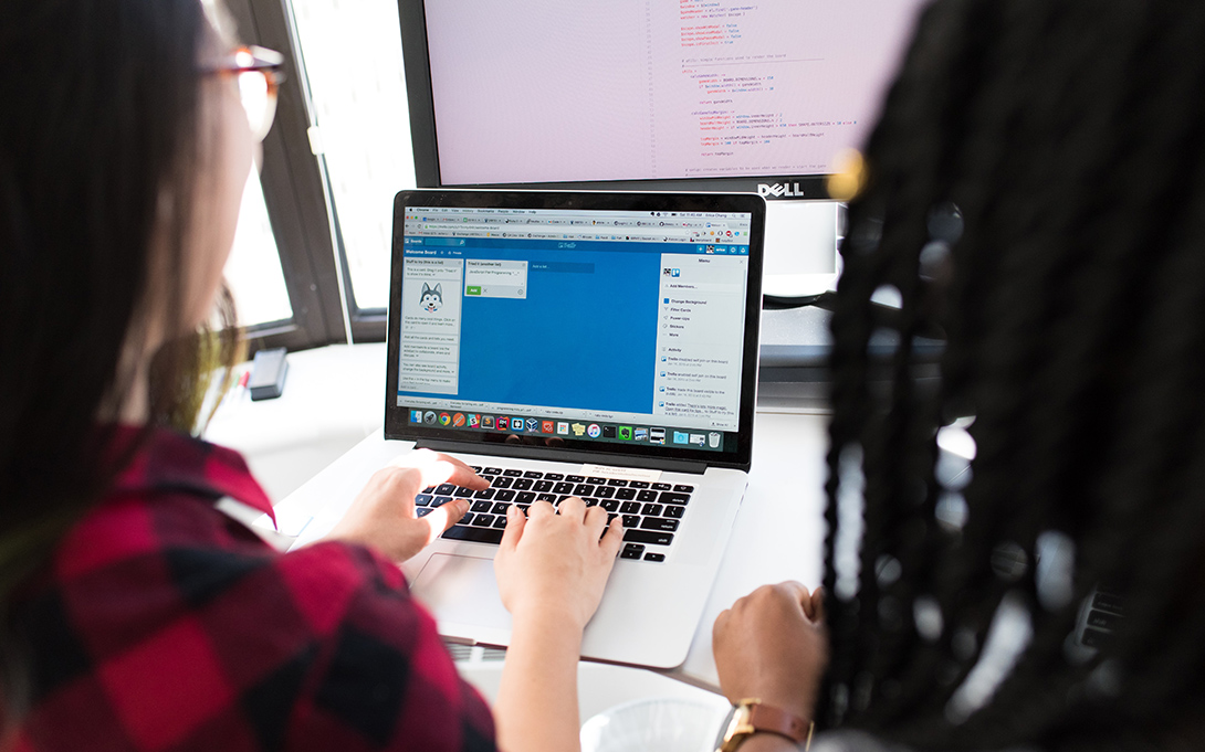 Two young people sitting at a computer