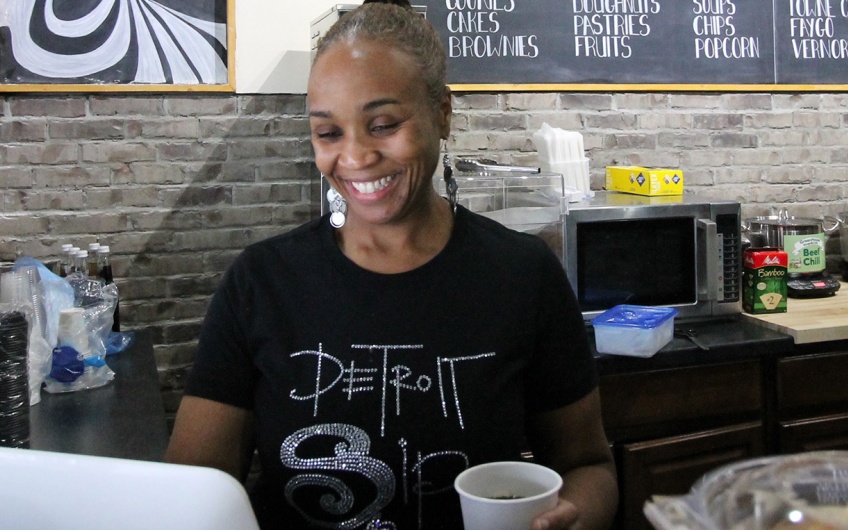 Business owner standing in her coffee shop