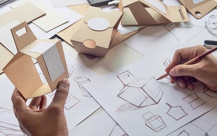 Person sketching packaging designs