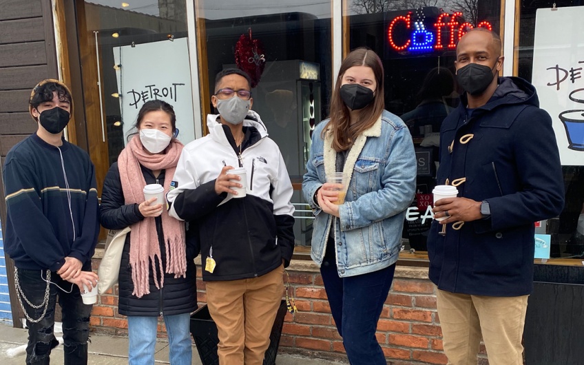 Students outside a cafe with masks