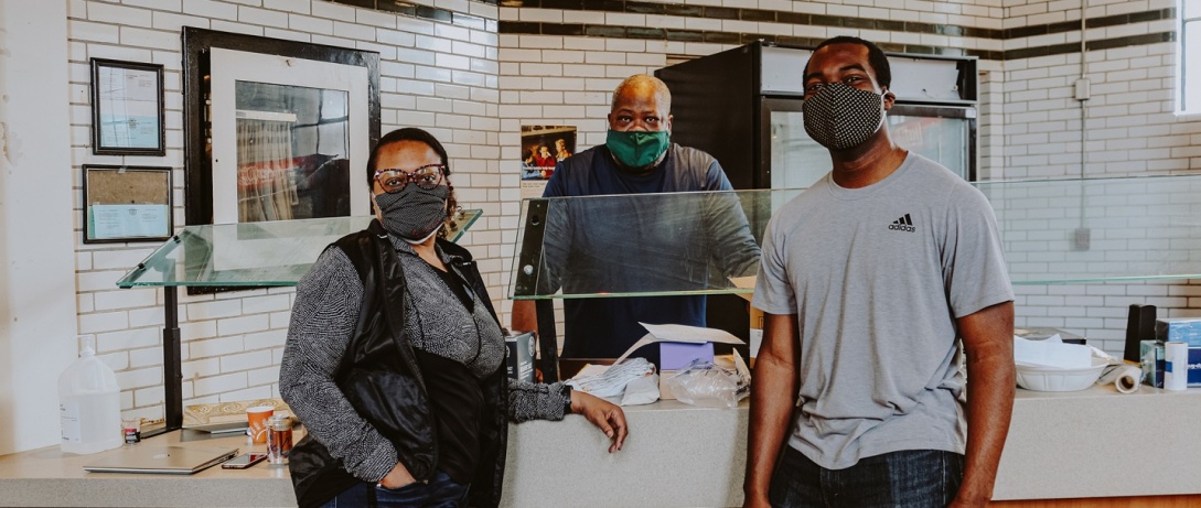 Farmacy Foods counter with people wearing masks in front of it