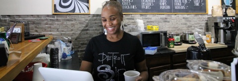 Business owner standing in her coffee shop